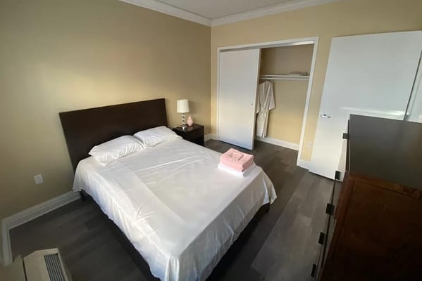 A well-appointed bedroom with a double bed, bedside lamp, and towels.