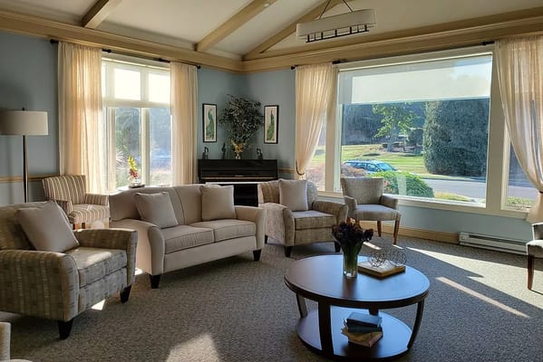 Bright living room with comfortable seating and large windows