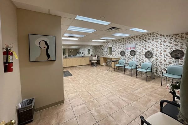Hair salon area with chairs and hairdryers in Spring Village at Danbury