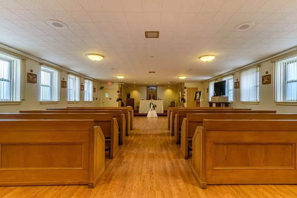 Interior view of the chapel with empty pews and altar