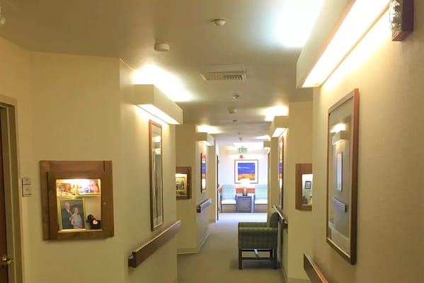 Interior hallway with framed photos and seating area