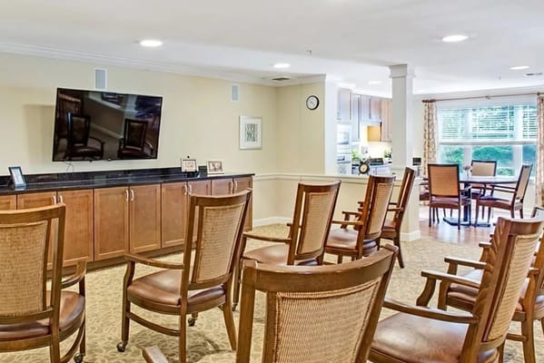 Seating area with chairs facing a television in the common room
