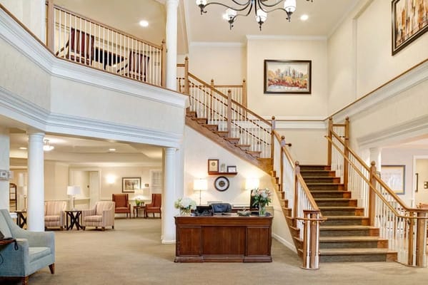 Bright and welcoming lobby with staircase and seating areas
