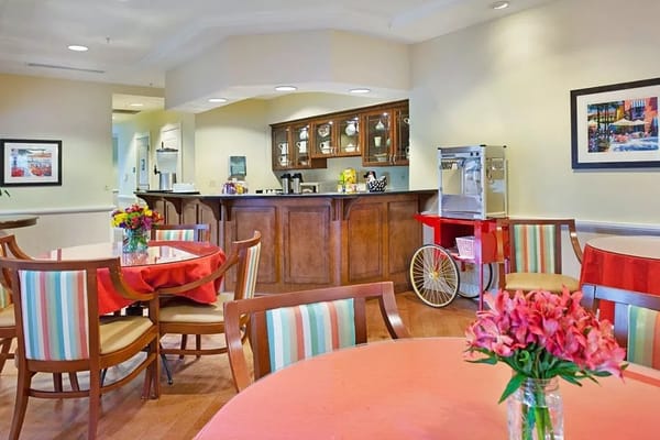 Cozy seating area with colorful tables and a refreshment bar