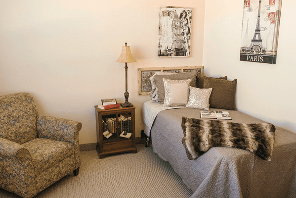 Cozy private room with a bed and armchair