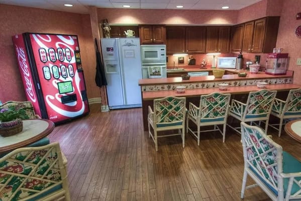 Café area featuring a vending machine and seating at Pheasant Ridge Nursing and Rehab Center