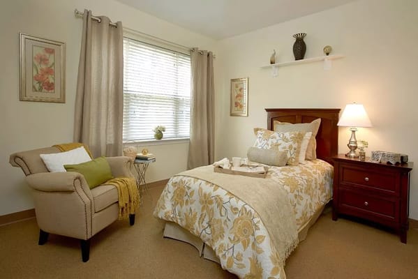 Cozy bedroom with floral bedding and armchair