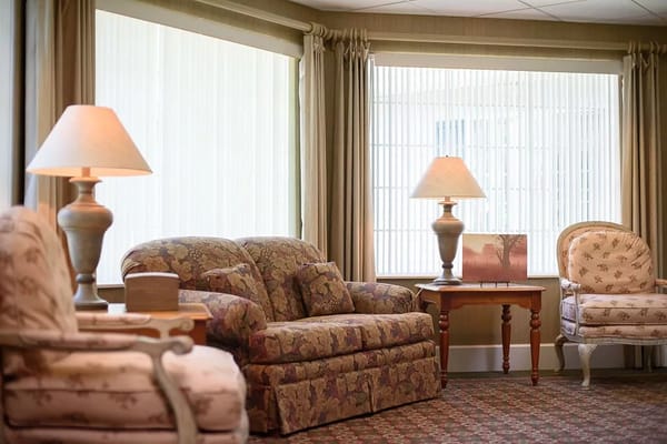 Cozy common area with floral couches and lamps