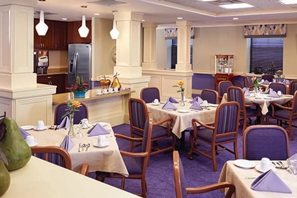 Dining area with tables set for meals at The Bristal at White Plains