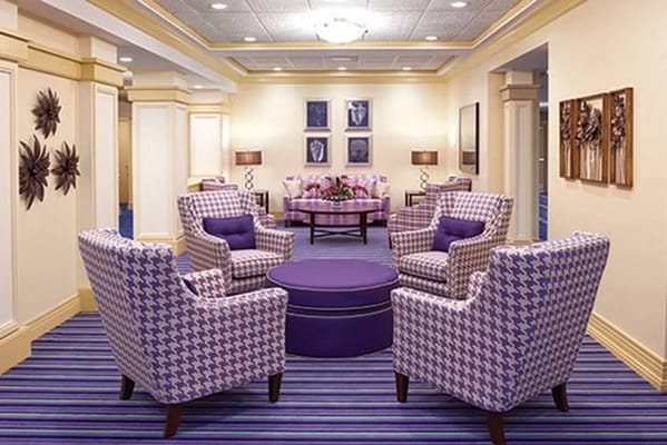 Cozy lounge with patterned chairs and a round table