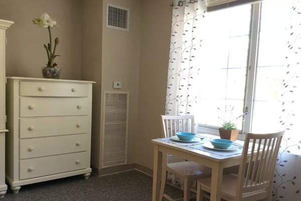 Bright dining area with a small table set for two