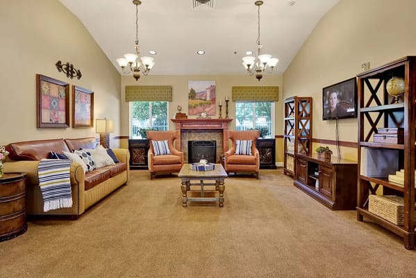 A warmly decorated living room with comfortable seating and a fireplace.