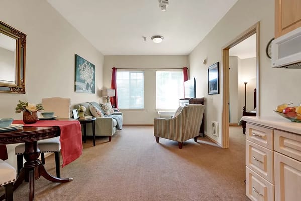 Bright living room with seating and a dining table