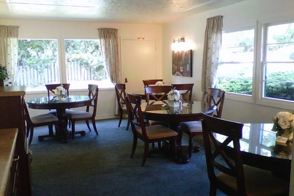 Bright dining area with tables set for residents
