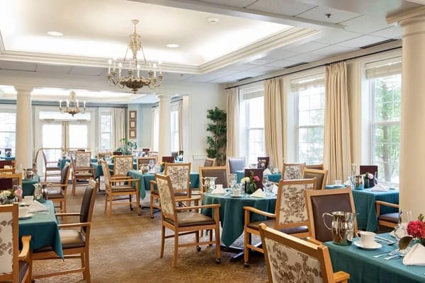 Dining room with tables set for meals at The Fountains at RiverVue