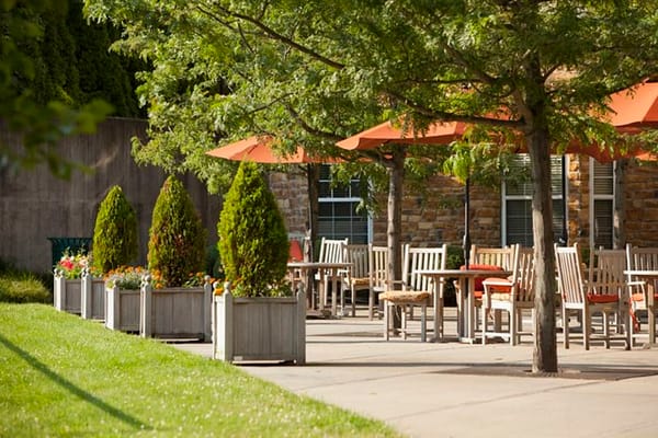 Outdoor dining area with tables and orange umbrellas
