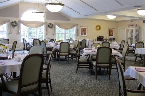 Dining area with tables and chairs set up for meals