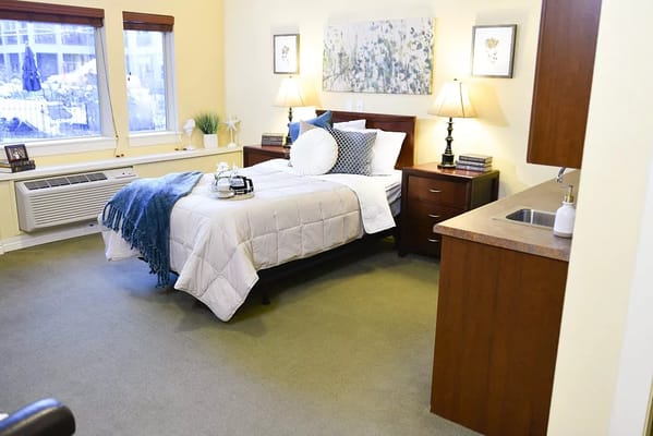 Comfortable resident room with a bed and furnishings