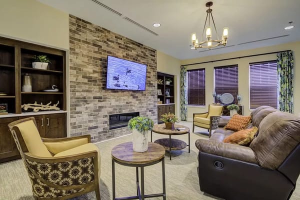 Living room with comfortable seating and a TV in The Lodge at Grand Junction.