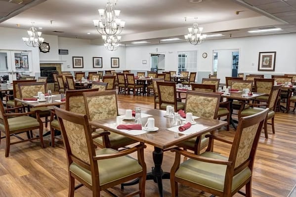 Spacious dining area with tables and chairs set for meals