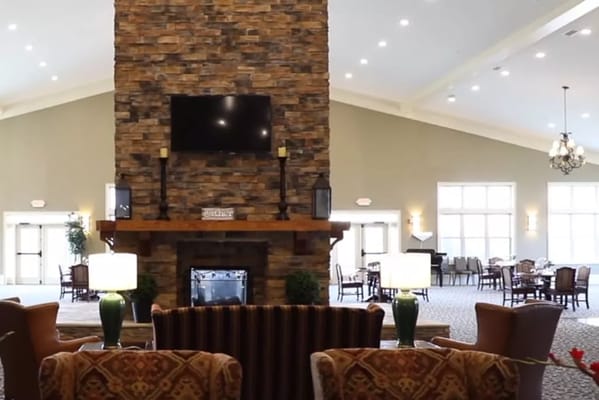 Spacious lobby featuring a stone fireplace and seating area.
