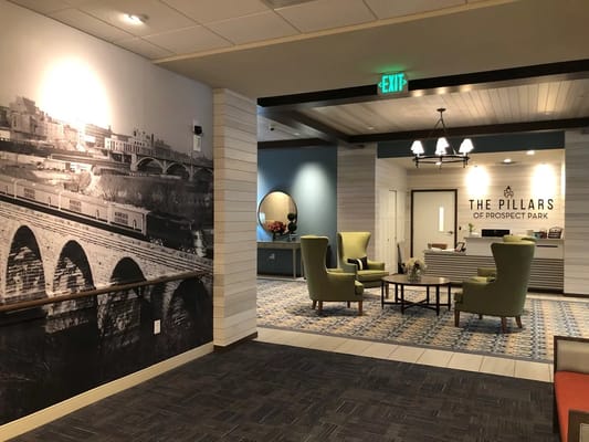 Cozy lobby with seating and historical wall mural
