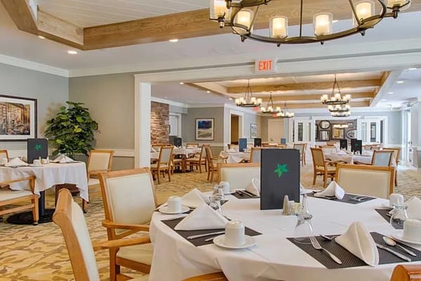 Dining room setup with tables and chairs at The Residences at Salem Woods