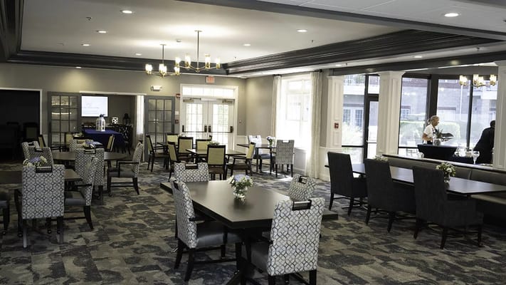 Dining area with tables and chairs in a bright setting