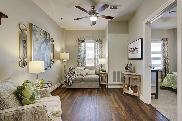 Spacious living room with a sofa, lamp, and decor