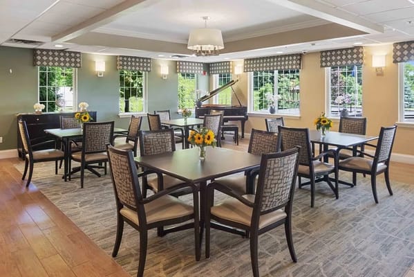 Bright common area with tables and flowers