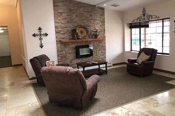 Cozy living room with two recliners and a stone fireplace
