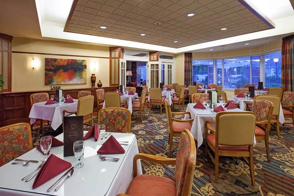 Interior view of a dining room with tables set for meals