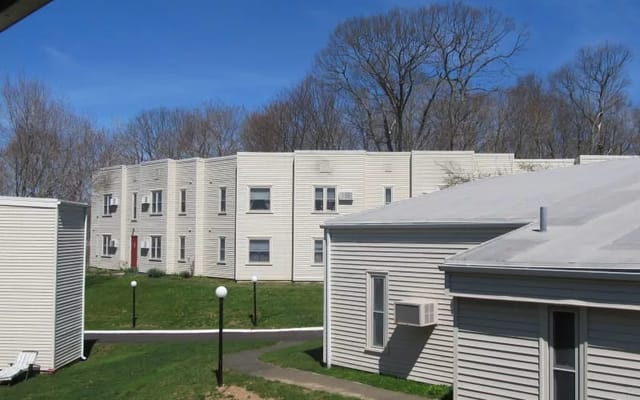 Exterior view of Parkside Village with grassy area and trees