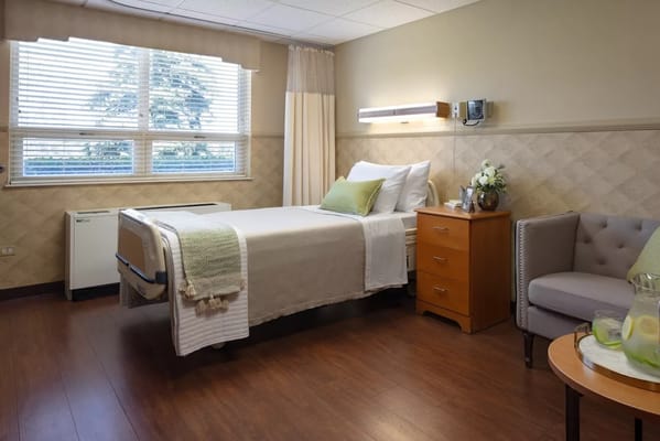Bright, well-furnished resident room in a senior living facility