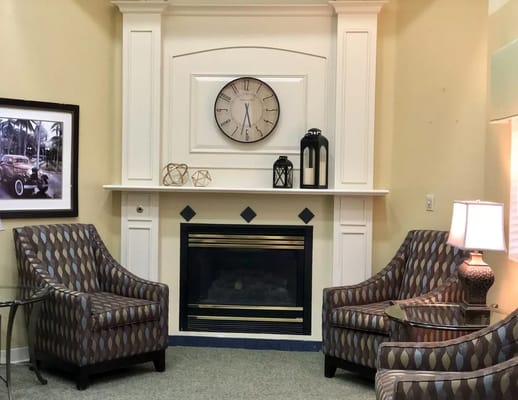 Cozy common area with chairs and a fireplace