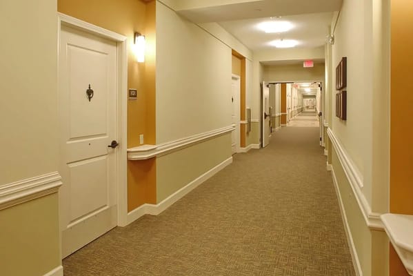 Interior hallway of a senior living facility with rooms