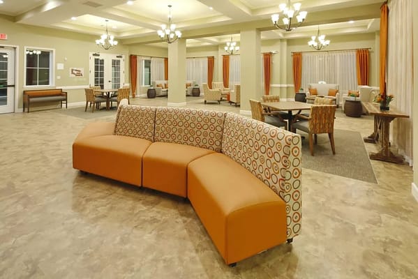 Cozy lounge area with orange seating and tables