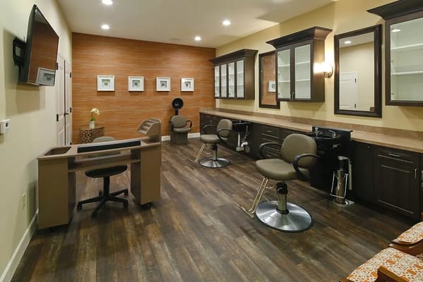 Interior view of the hair salon with chairs and mirrors.