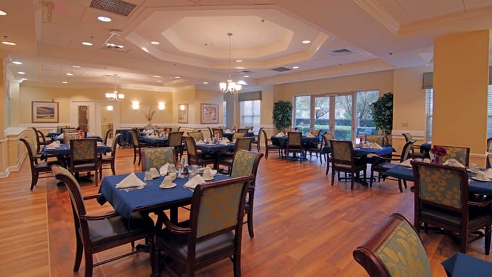 Dining area with wooden floors and blue table settings