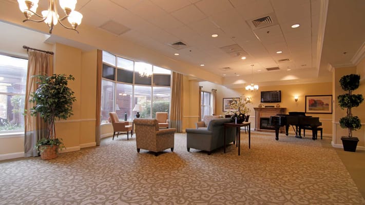 Bright common area with seating and piano