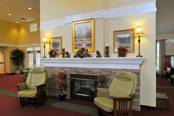 Common area with chairs and fireplace decorations