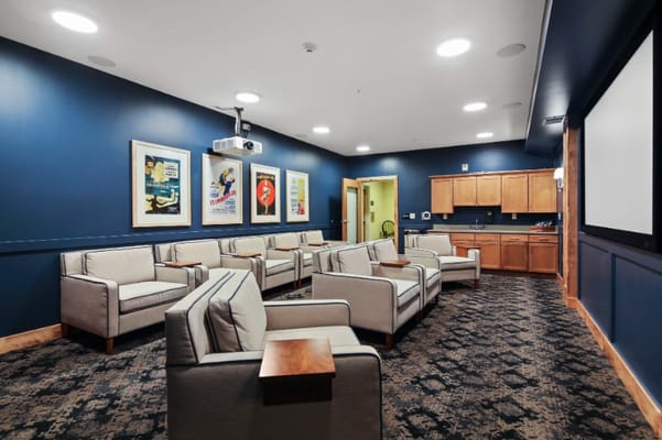 Interior activity room with seating and projector