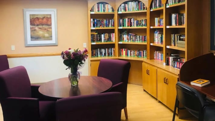 Cozy reading nook with bookshelves and flowers