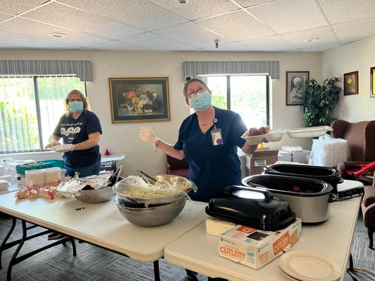 Staff serving food in a common area of the facility