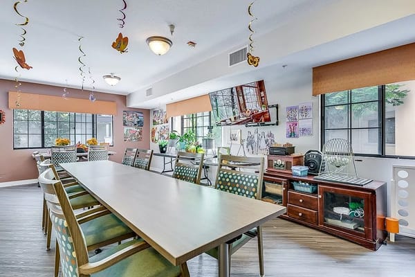 Bright and welcoming dining area with a long table and decorated walls