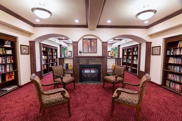 Cozy library area with comfortable seating and bookshelves