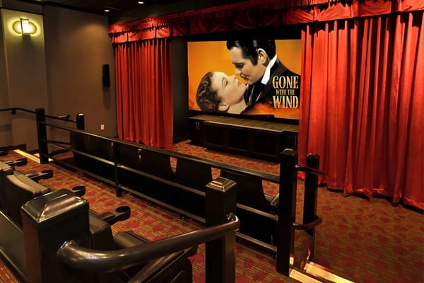 Inside a cozy theater room with a classic film showing