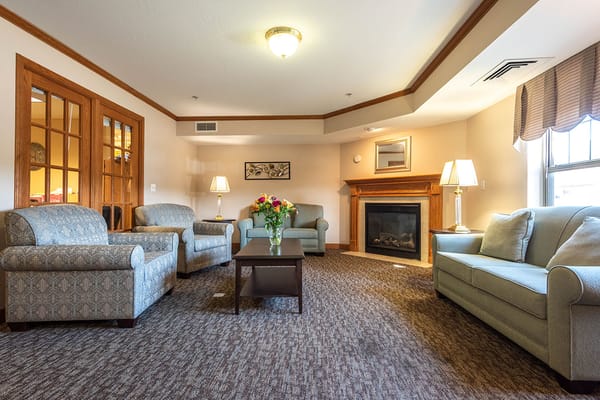 Bright common area with seating and a fireplace