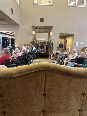 Group of seniors attending an event in the living room of Wood-Lawn Heights.