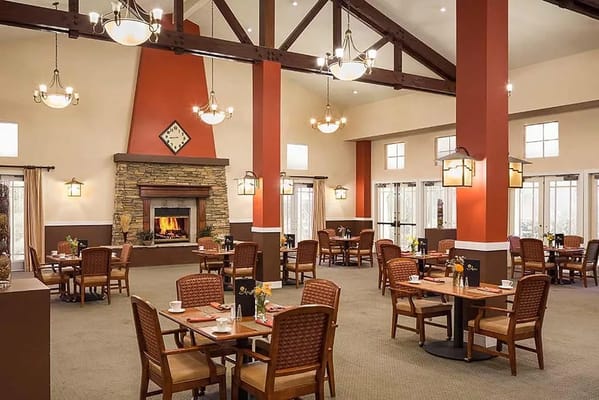 Cozy dining area with tables and chairs in a senior living facility